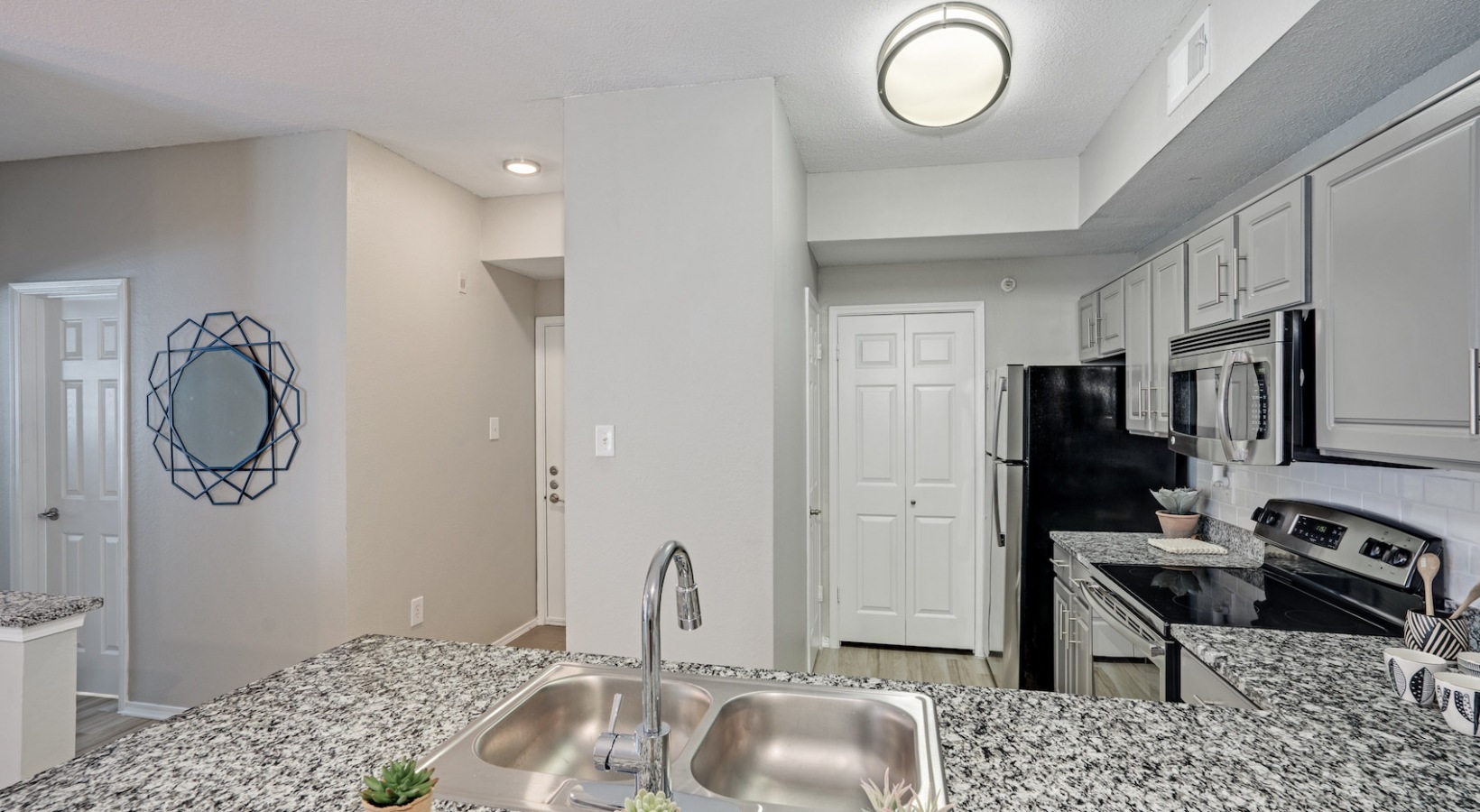 a kitchen with granite counter tops and stainless steel appliances at The  Lana
