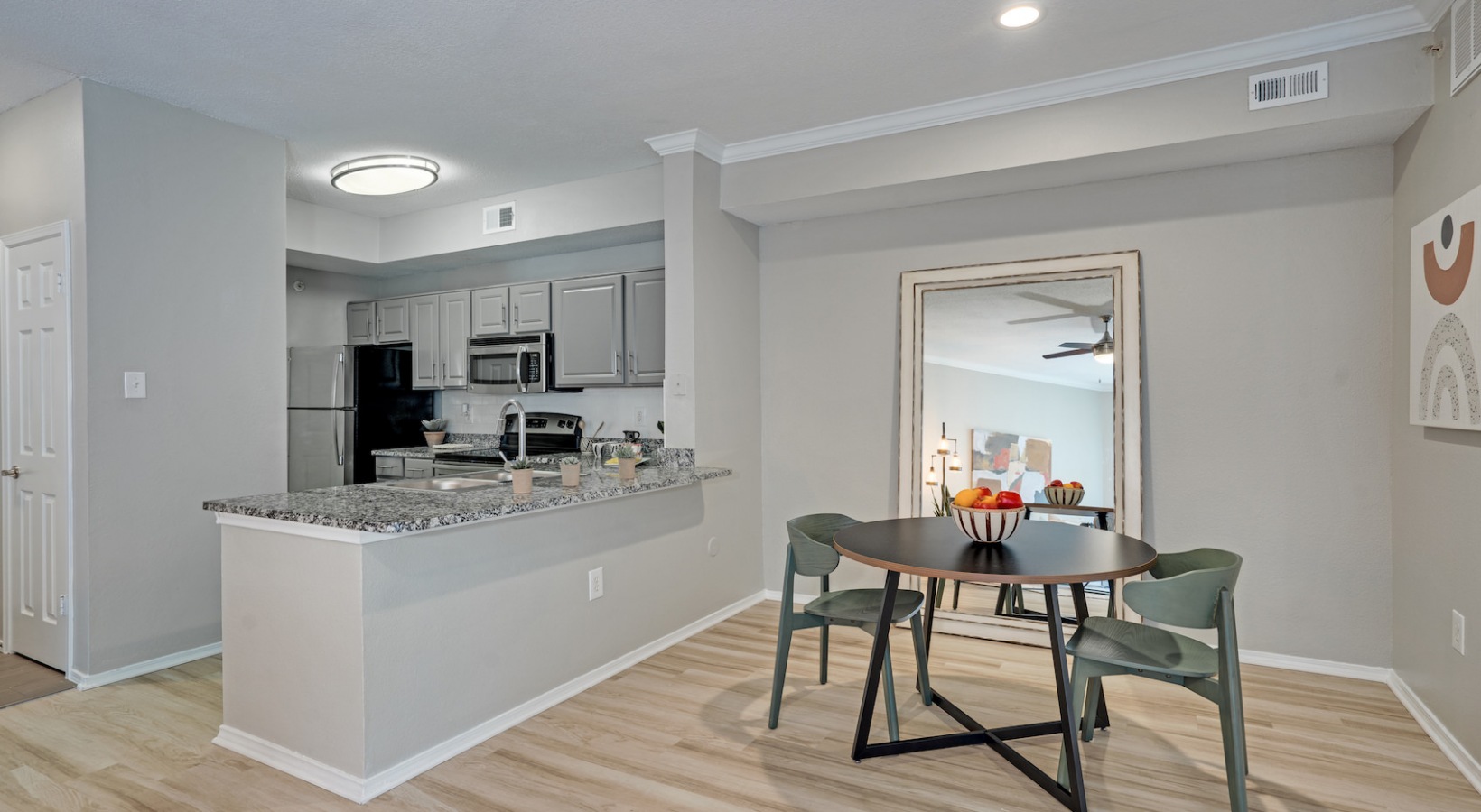a kitchen and dining room area with a table and chairs at The  Lana