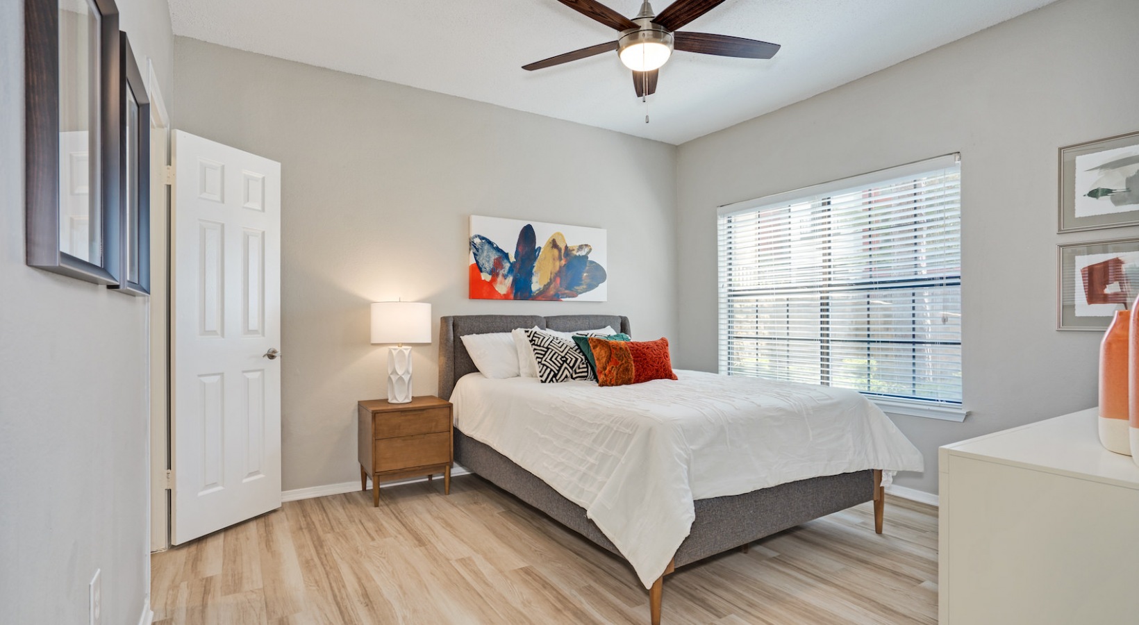 a bedroom with hardwood floors and a ceiling fan at The  Lana