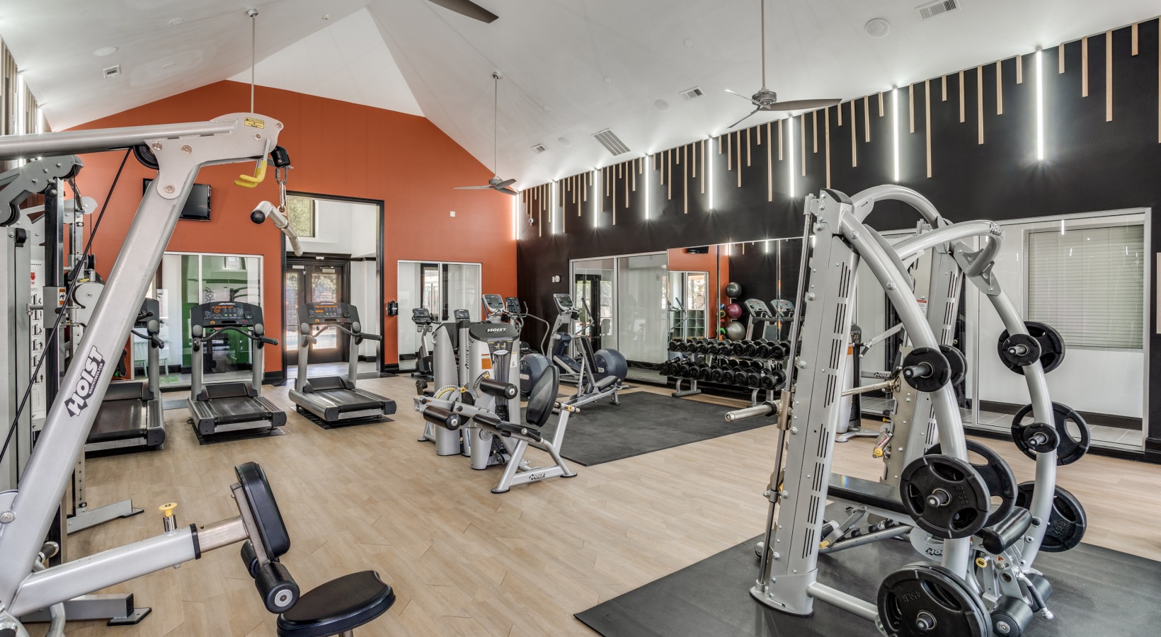 a gym room with a variety of equipment at The  Lana