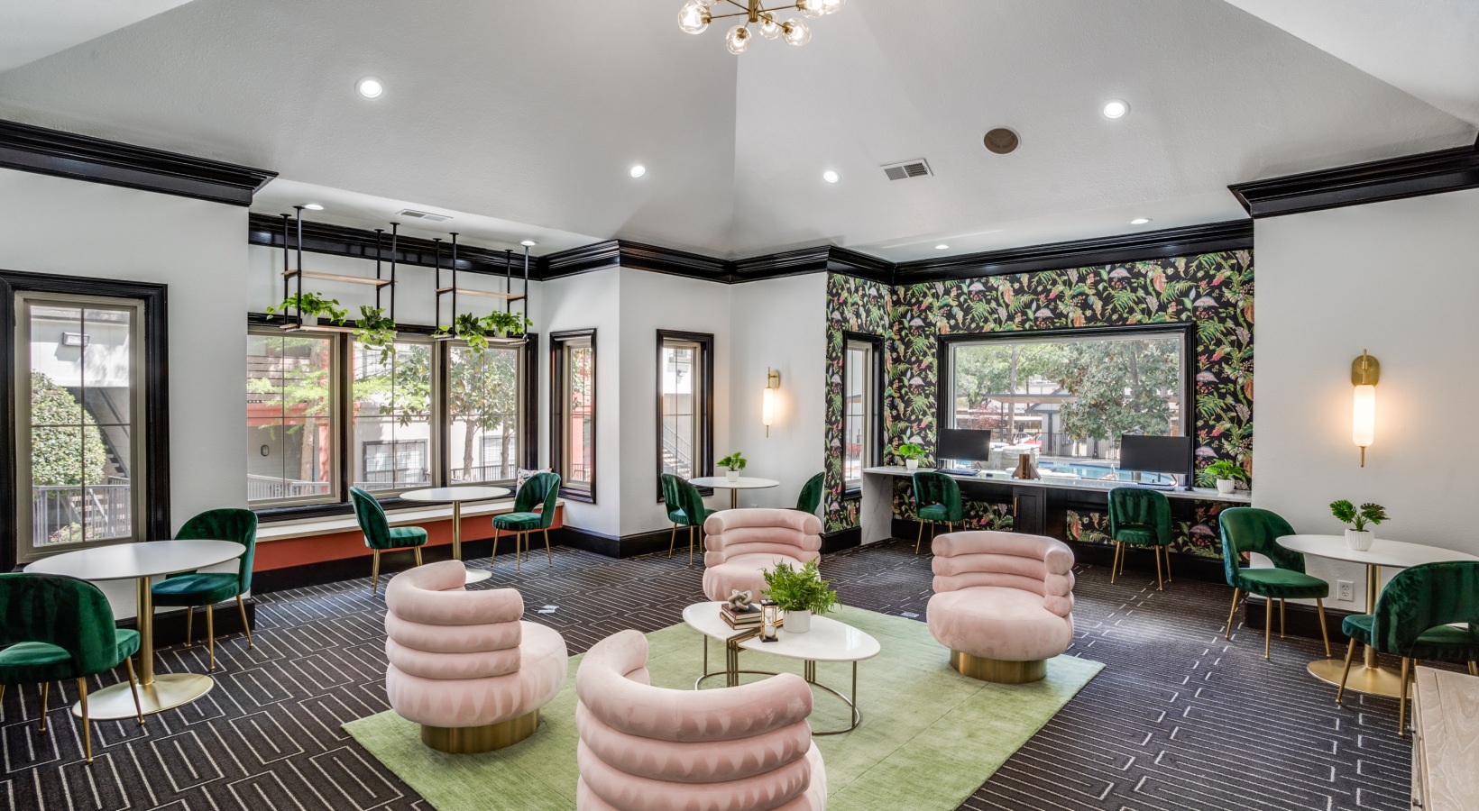 the lobby of a hotel with green chairs and pink walls at The  Lana