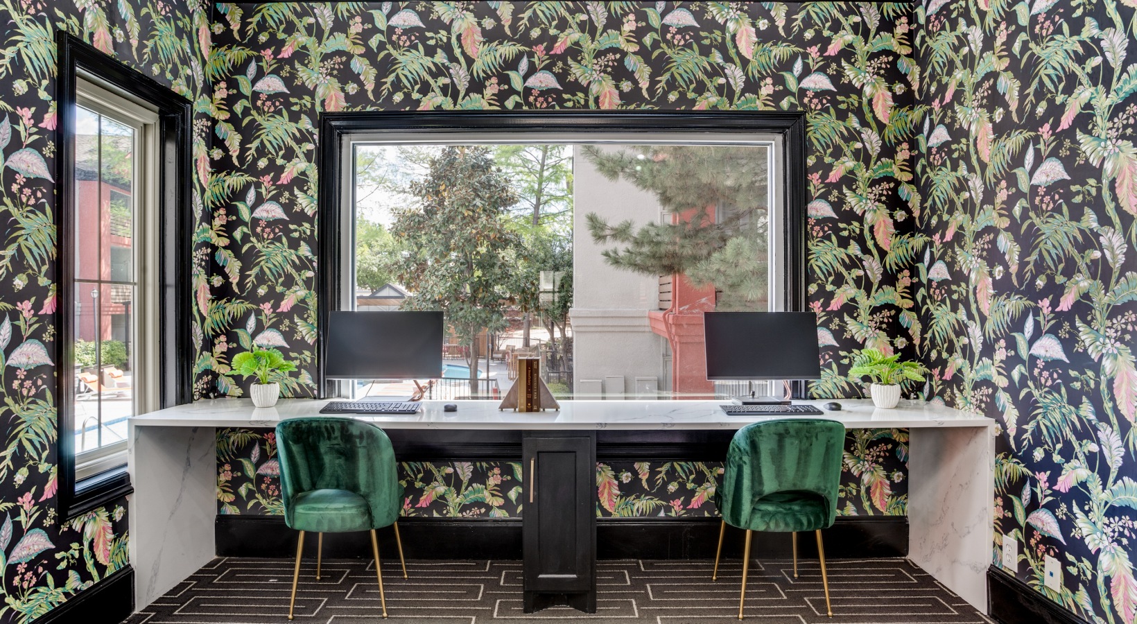 a home office with green chairs and a black and white wallpaper at The  Lana
