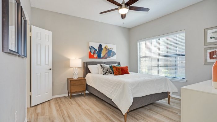 a bedroom with hardwood floors and a ceiling fan at The  Lana